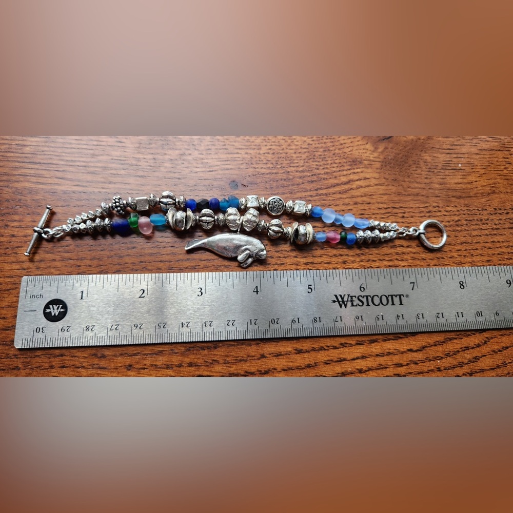 Silver bracelet with silver and glass beads and manatee charm